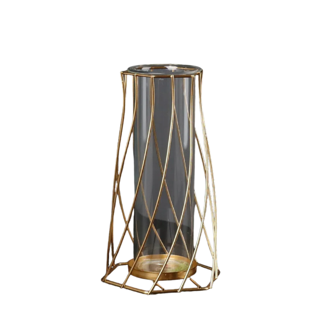 Modern clear glass vase with geometric gold metal frame on black background