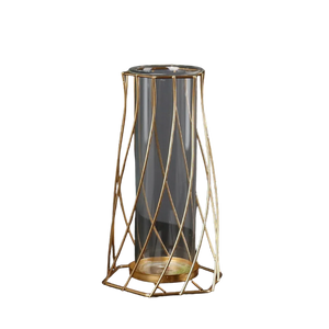 Modern clear glass vase with geometric gold metal frame on black background