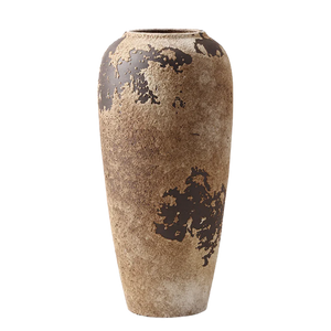 Tall rustic brown ceramic vase with weathered textured finish on a black background