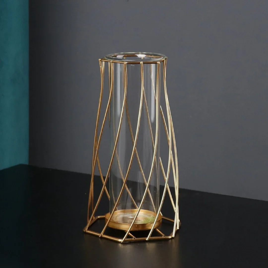Modern glass vase with geometric gold metal frame on black tabletop