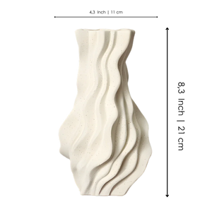 Modern ceramic vase with wavy textured surface in matte off-white finish