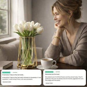 Smiling woman at table with white tulips in modern gold vase, coffee cup, and customer reviews.