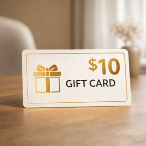 $10 gift card with gold gift box icon on table in bright home setting